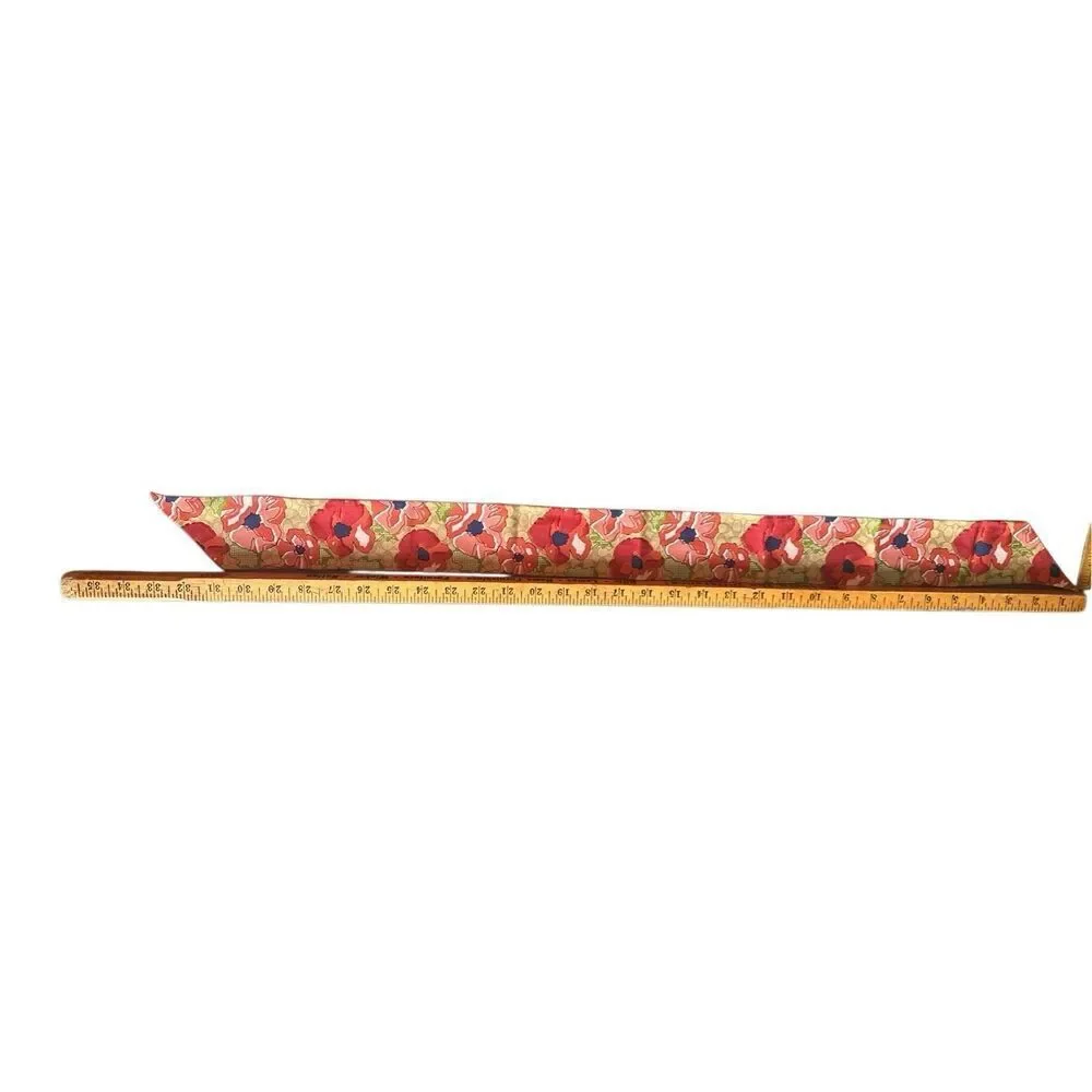 COACH silk twilly scarf orange poppy and tan signature Cs background